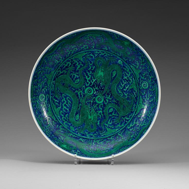 A large green enamelled blue and white dragon dish, Qing dynasty with Kangxi's six character mark.