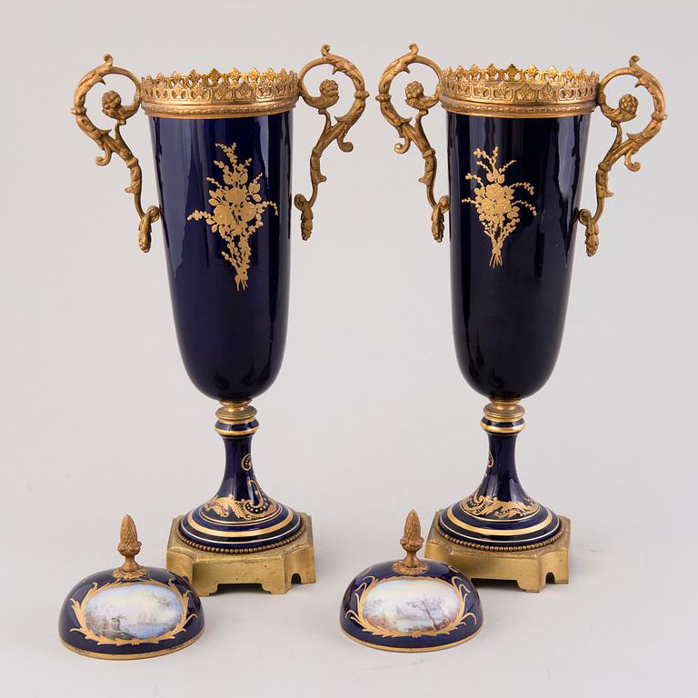 Pair of Sevres Chateau des Tuileries porcelain lidded urns, mid-19th century.