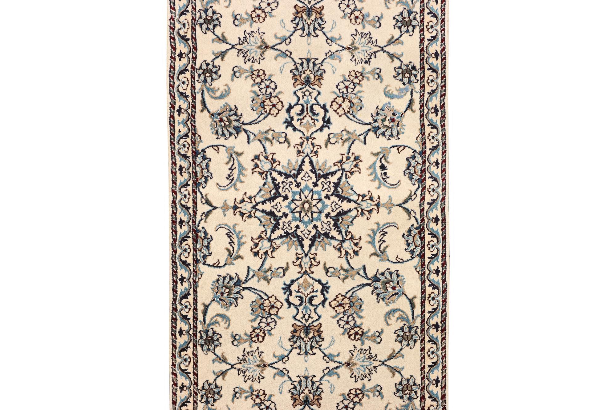 A Nain runner carpet, part silk, c. 298 x 80 cm.