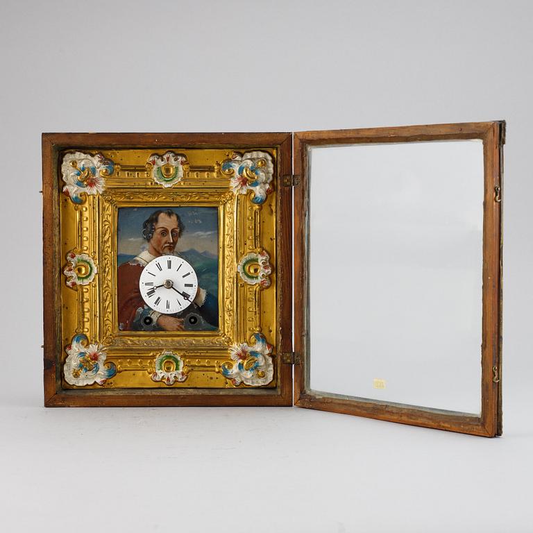 A Schwarzwald area wall pendulum clock with mechanical eye-movment, mid 19thcentury.