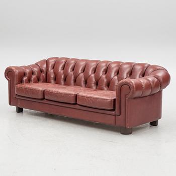 A sofa and a pair of armchairs, 'Chesterfield model', late 20th Century.