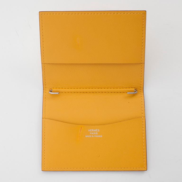 HERMÈS, a yellow leather agenda cover, "Globe Trotter".