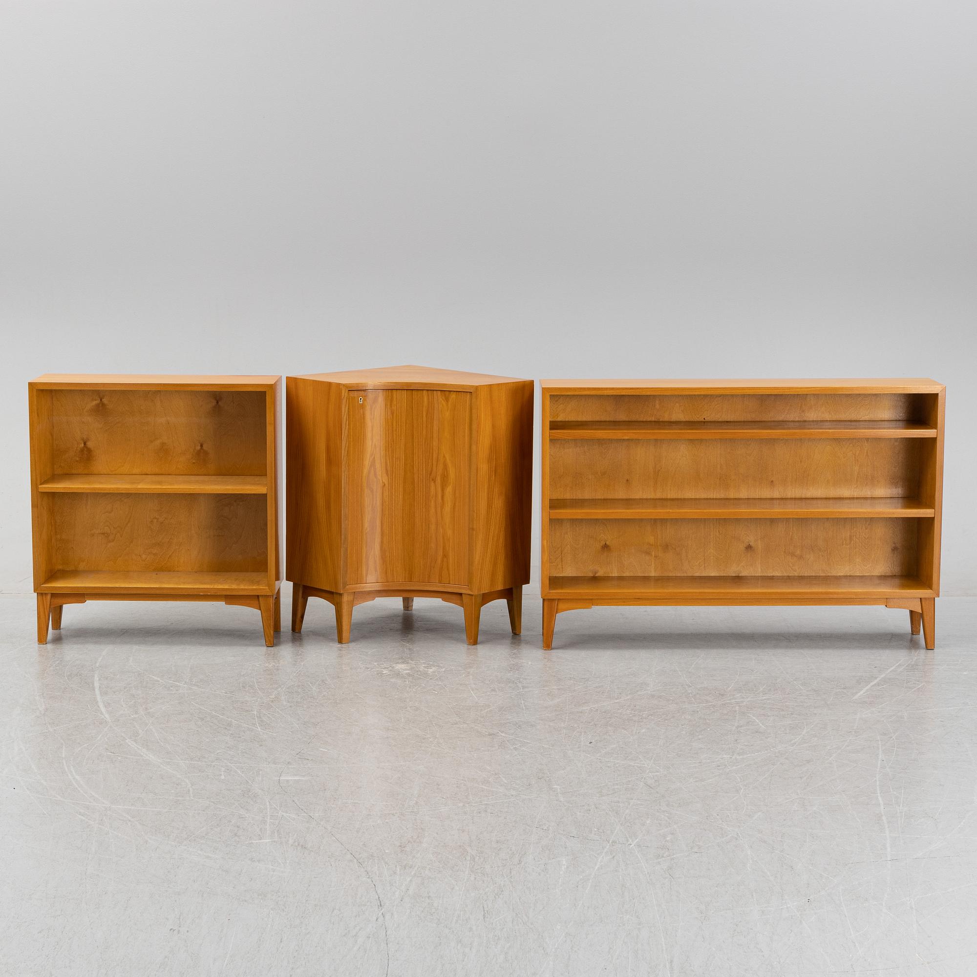 A three piece corner book case with a cabinet.