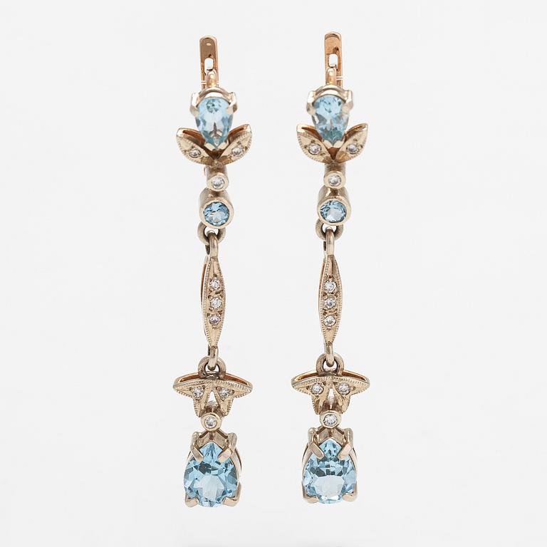 A pair of 14K gold earrings with diamonds ca. 0.18 ct in total and topazes.