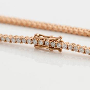 Tennis bracelet 14K gold with round brilliant-cut diamonds.