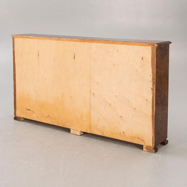 A 1930s birch book cabinet.