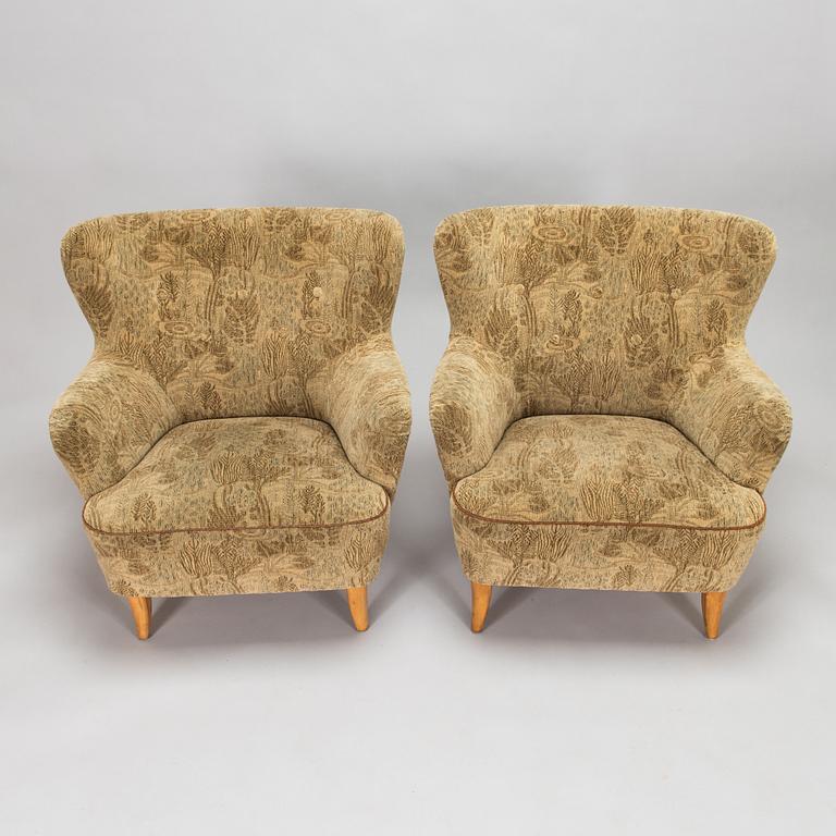 A pair of 1950s armchairs.