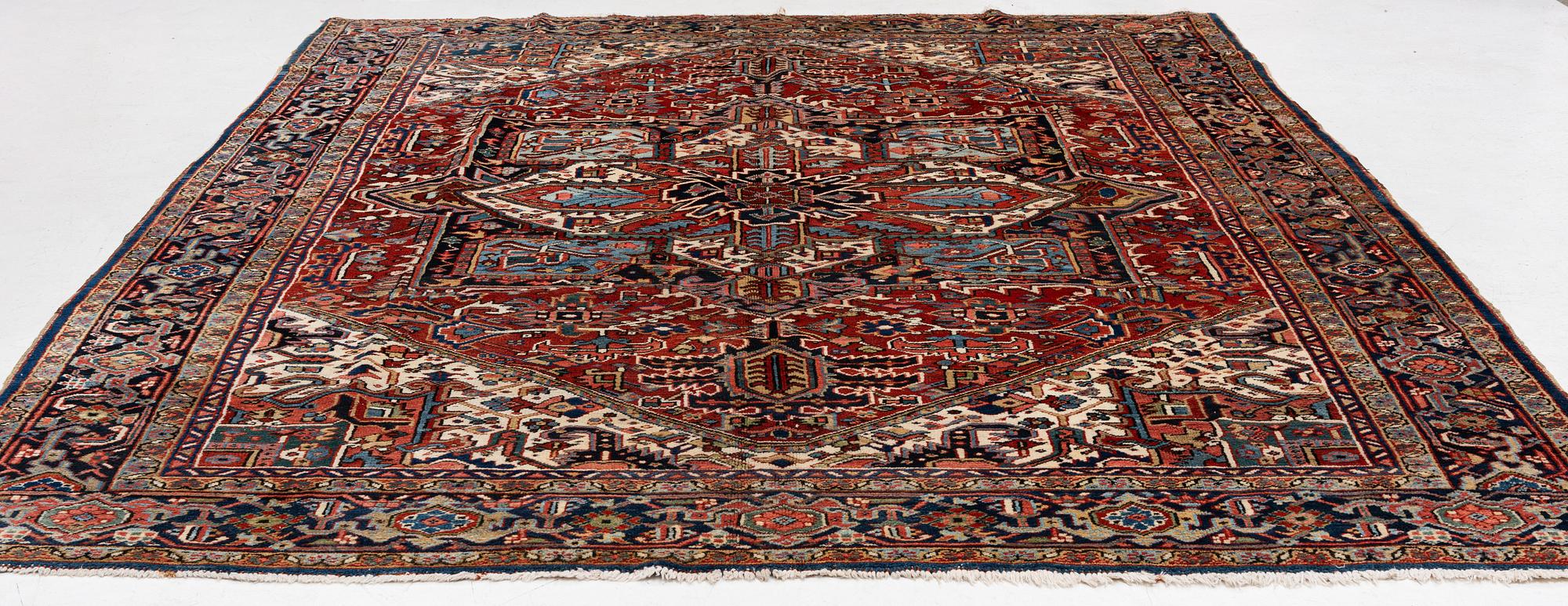 A semi-antique Heris carpet, c. 364 x 299 cm.