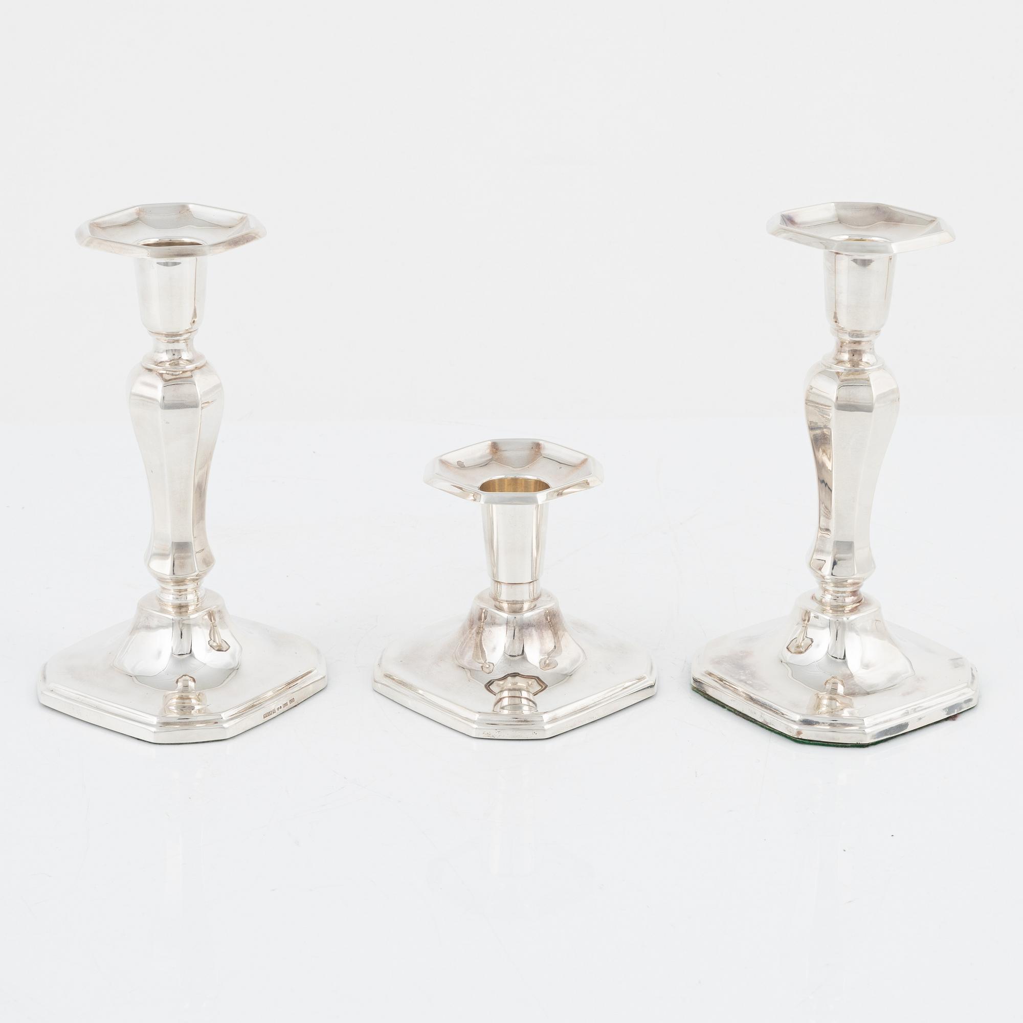 A pair of silver candlesticks, MGAB, Uppsala, 1985 and a silver candlestick, MEMA, Lidköping, 1987.