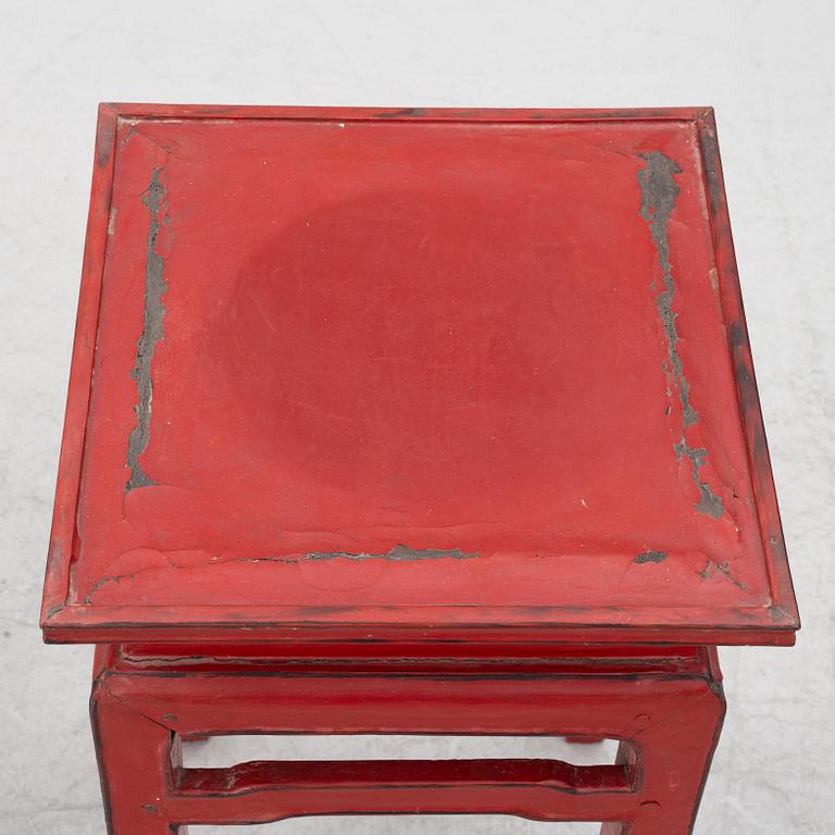 A pair of red Chinese small tables, 20th century.