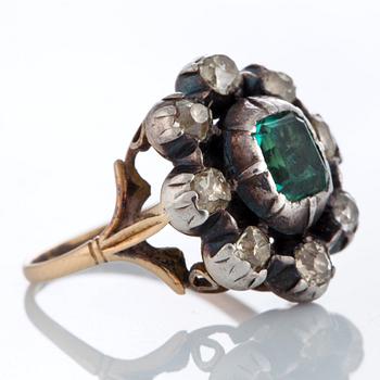 A ring set with an emerald and old-cut diamonds.
