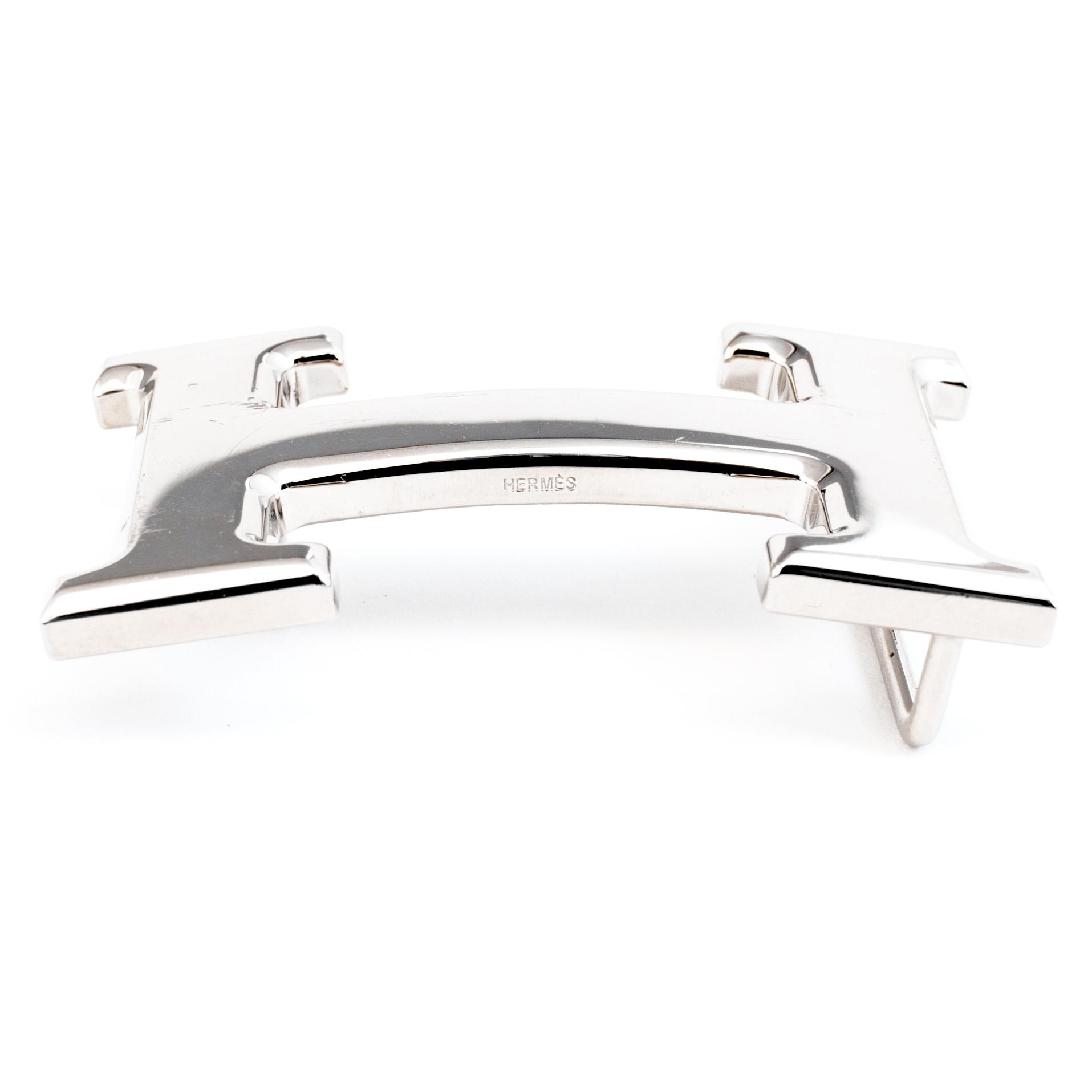 Brown togo belt "Constance" by Hermès.