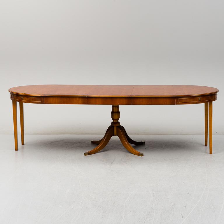 A yew dining table and 8 chairs, second half of the 20th century.