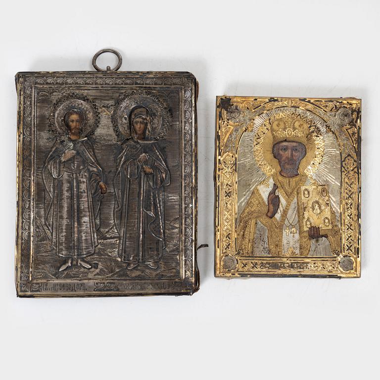 Two Russian icons with oklad, of which one in silver with stamps Moscow 1908-1926.
