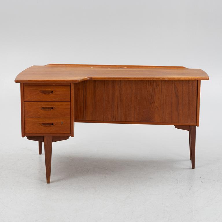 A teak veneered desk, 1950's/60's.