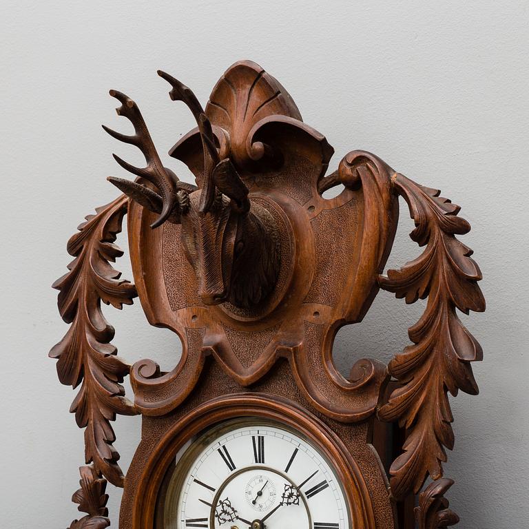 A Lenzkirch walnut wall clock from Germany, 1910s / 20s.