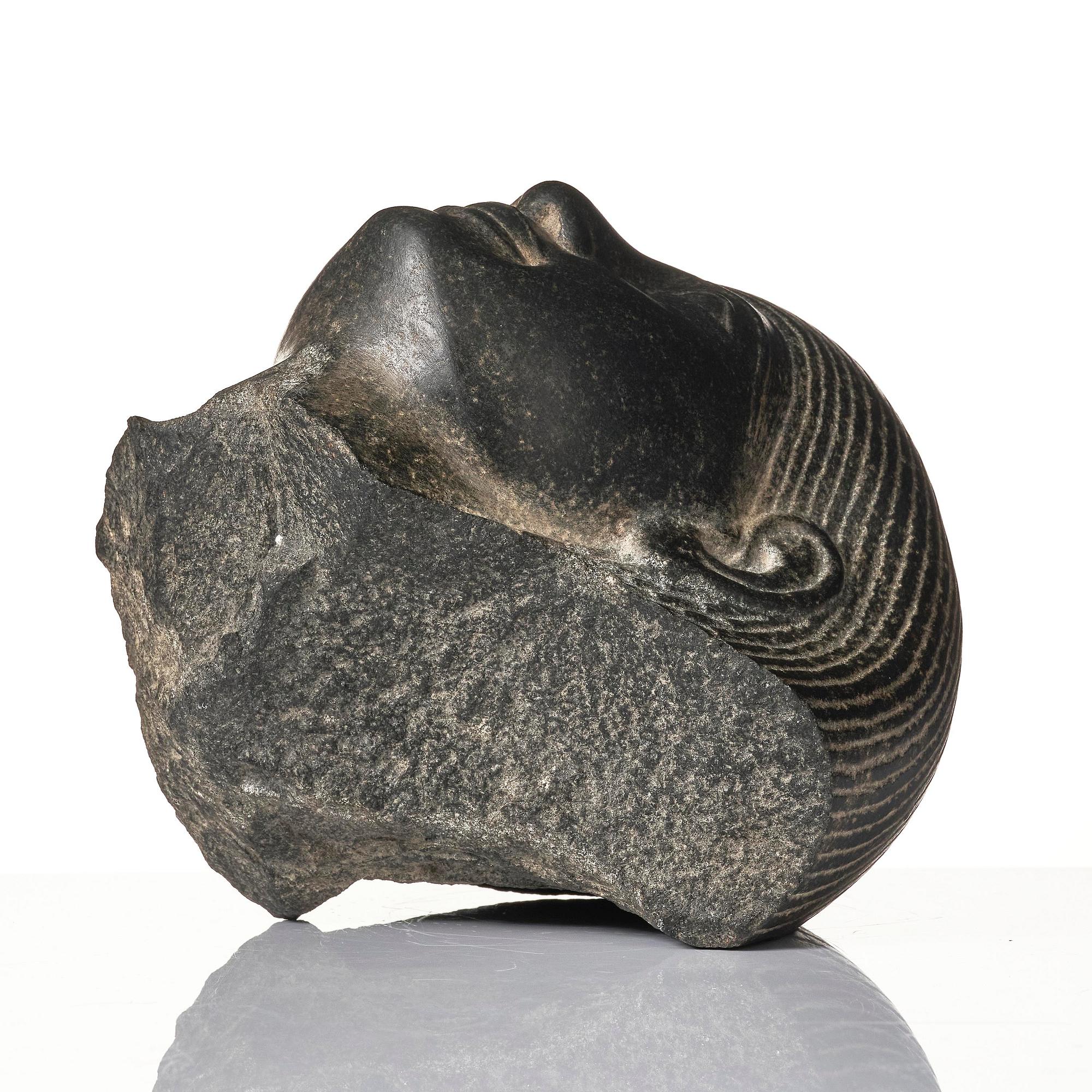 An Egyptian basalt head of a man, Grand tour, 19th century.