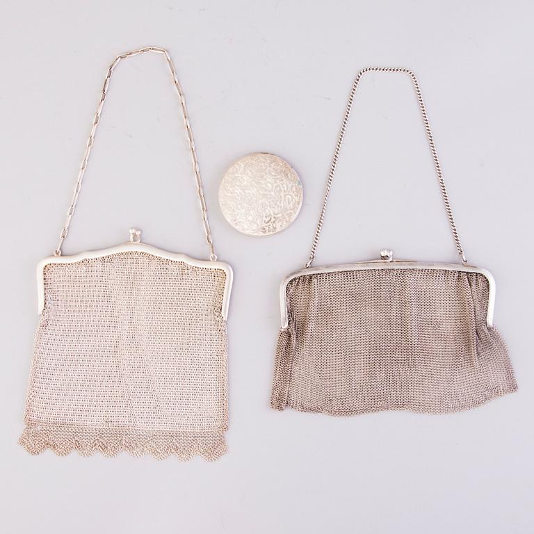 Two silver evening bags and a silver mirror, 1920s-1940s.