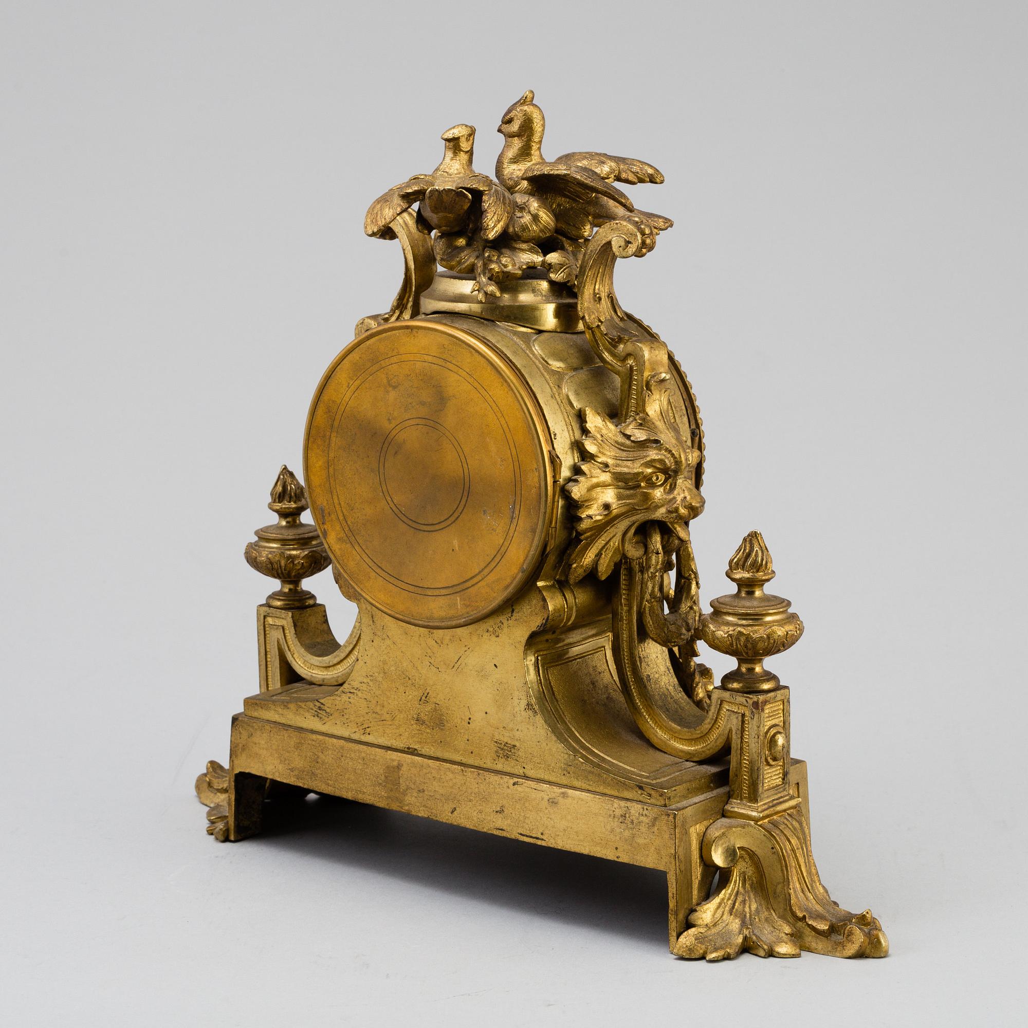 A table CLOCK and a pair of candelabra, second part of 19th century.