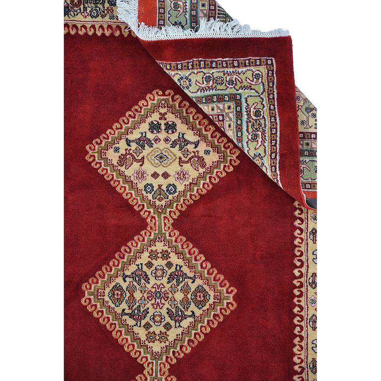 A Persian Rug, approximately 240 x 165 cm.