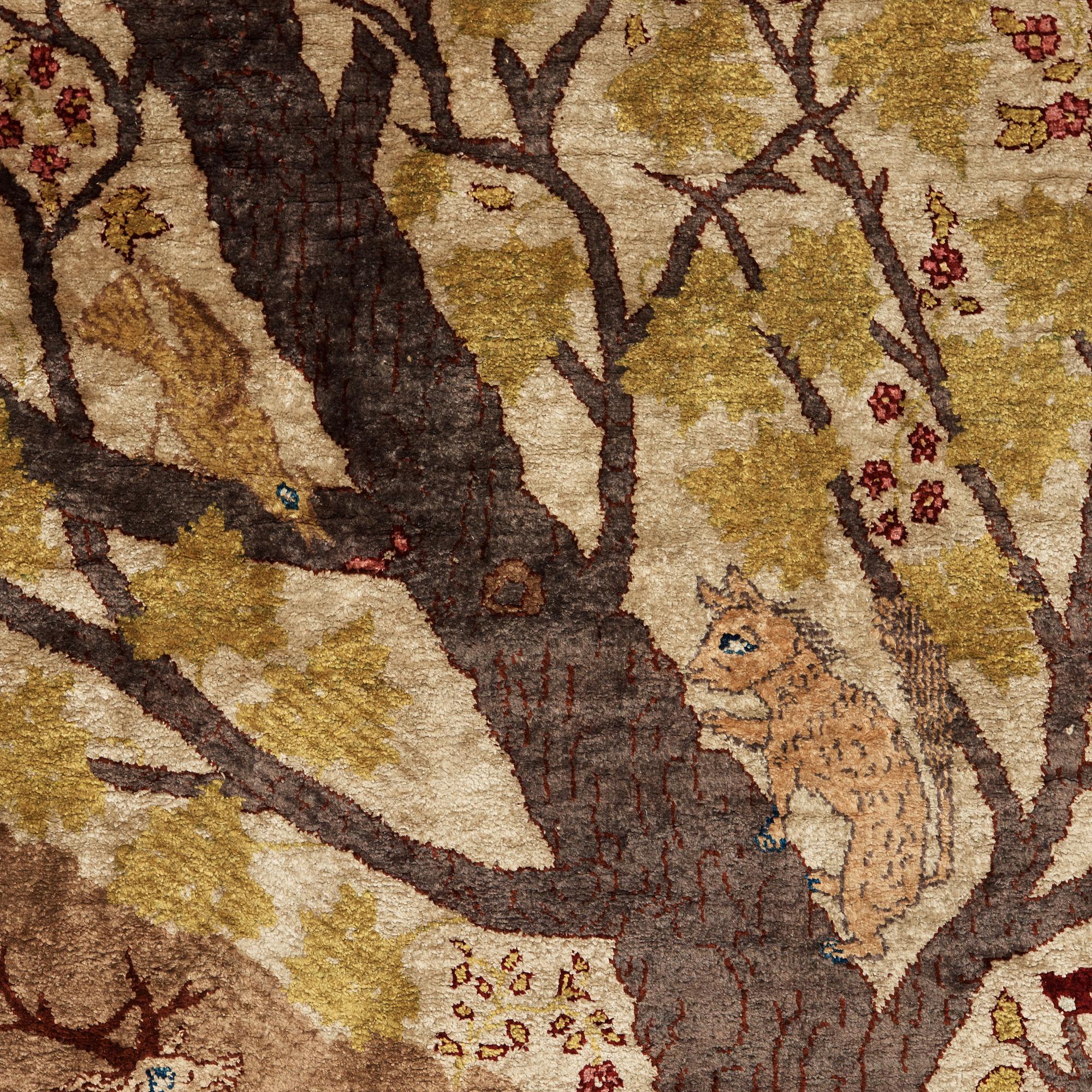 A CARPET, a semi-antique silk Tabriz figural, signed Haddad, 180,5 x 123,5 cm.