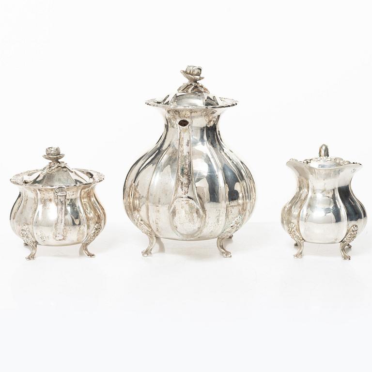 A Rococo style silver coffee pot, cream jug and sugar bowl, 20th century, Swedish import mark.