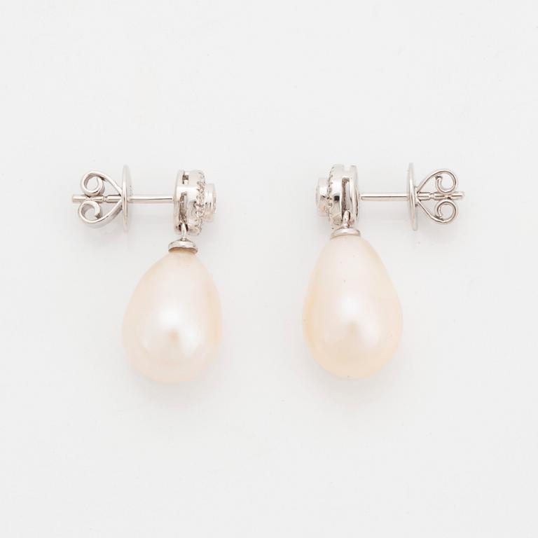 A pair of 18K white gold and cultured pearl earrings set with round brilliant-cut diamonds.