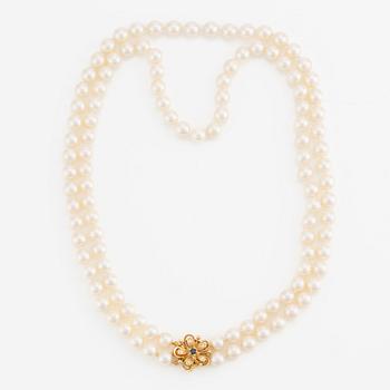 Necklace, double strand of cultured pearls, clasp in 18K gold set with eight-cut diamonds and a sapphire.