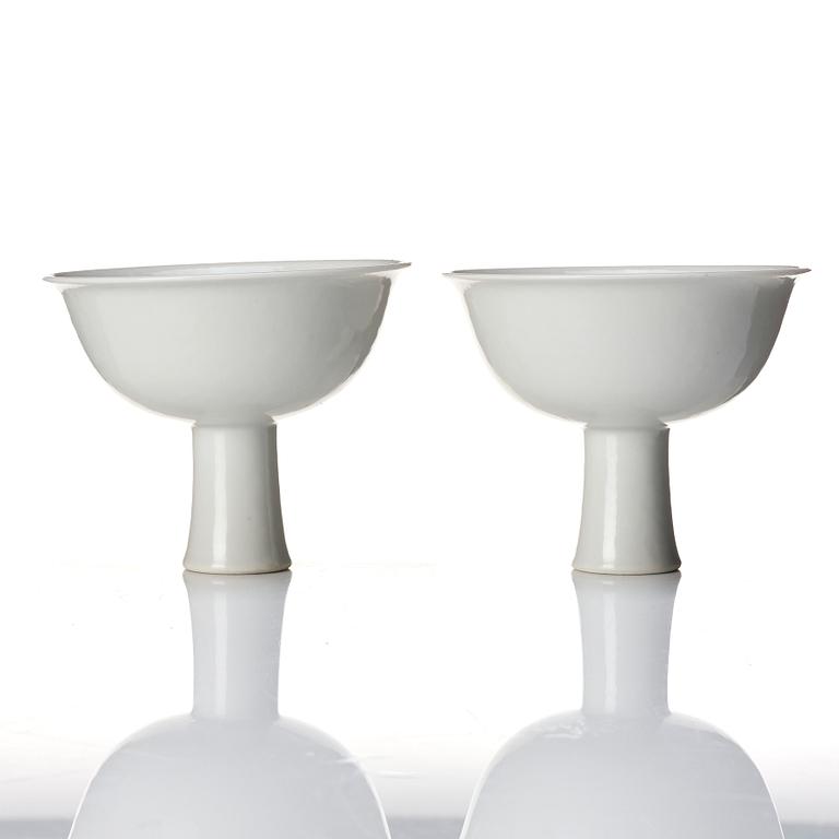 A pair of white glazed anhua stemcups, Qing dynasty, 19th Century.