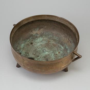 A 19th century brass cauldron.