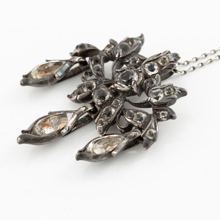 A brooch, a brooch pin, and a pendant, likely 19th century.