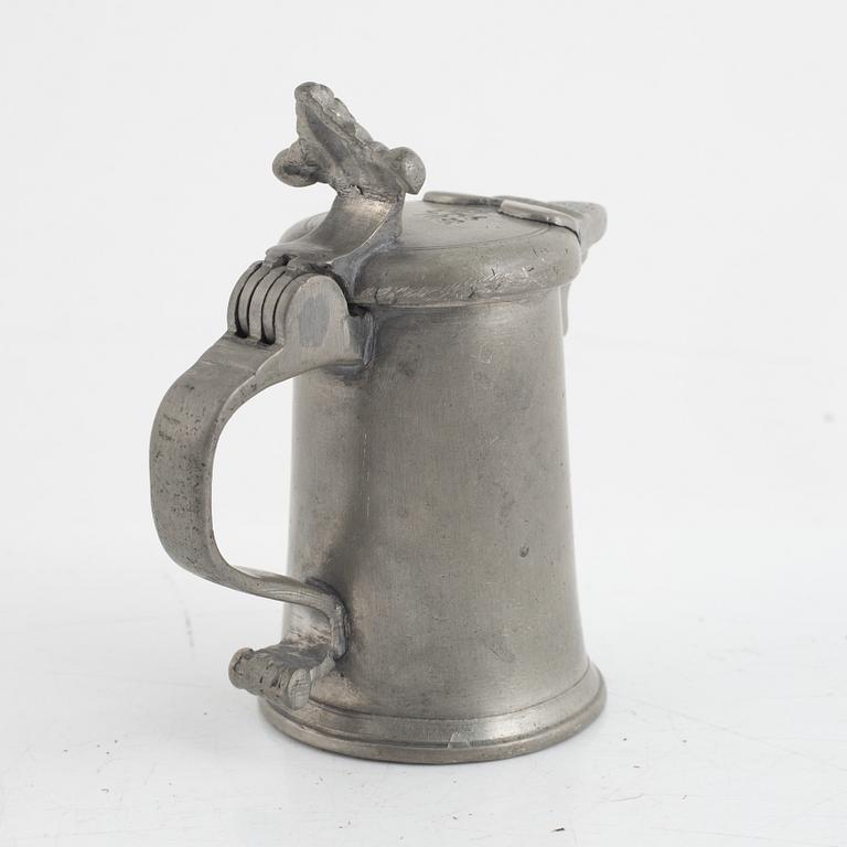 A pewter measuring cup by an unidentified master, dated 1766.