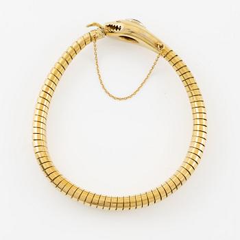 A bracelet in the shape of a serpent in 18K gold with a faceted citrine and rose-cut diamonds.