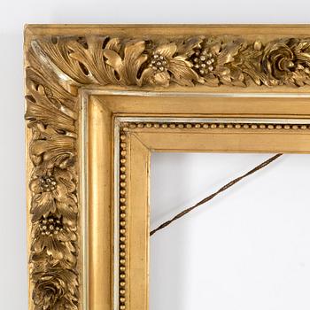 A wood frame with decorations of oak leaves. Circa 1900.