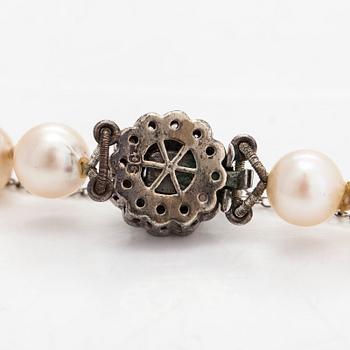 A cultured pearl necklace, clasp with white zircons.