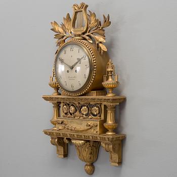 A Swedish Gustavian style gilt wood wall clock, marked Linderoth Stockholm, 20th century.