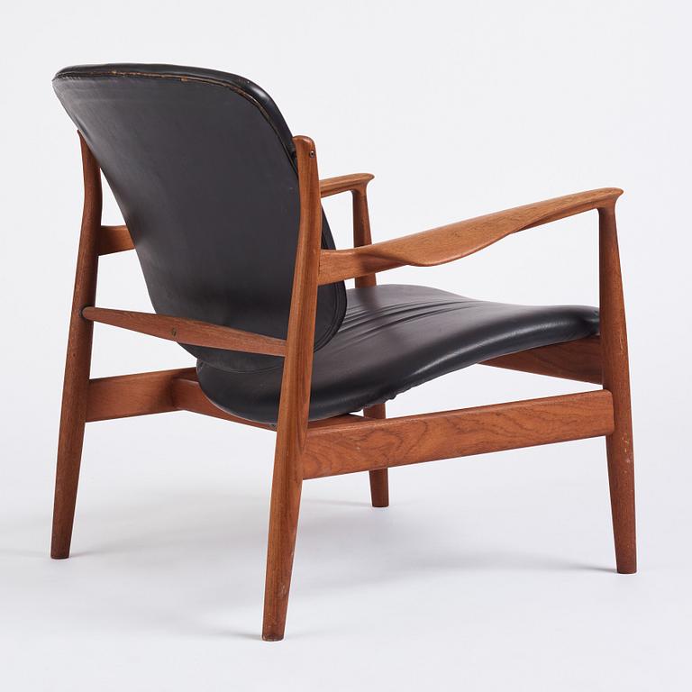 Finn Juhl, a teak and black leather 'model 136' easy chair, France & Daverkosen, Denmark 1950-60s.