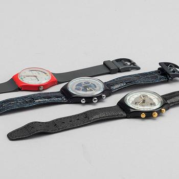 Three watches and one book by Swatch.