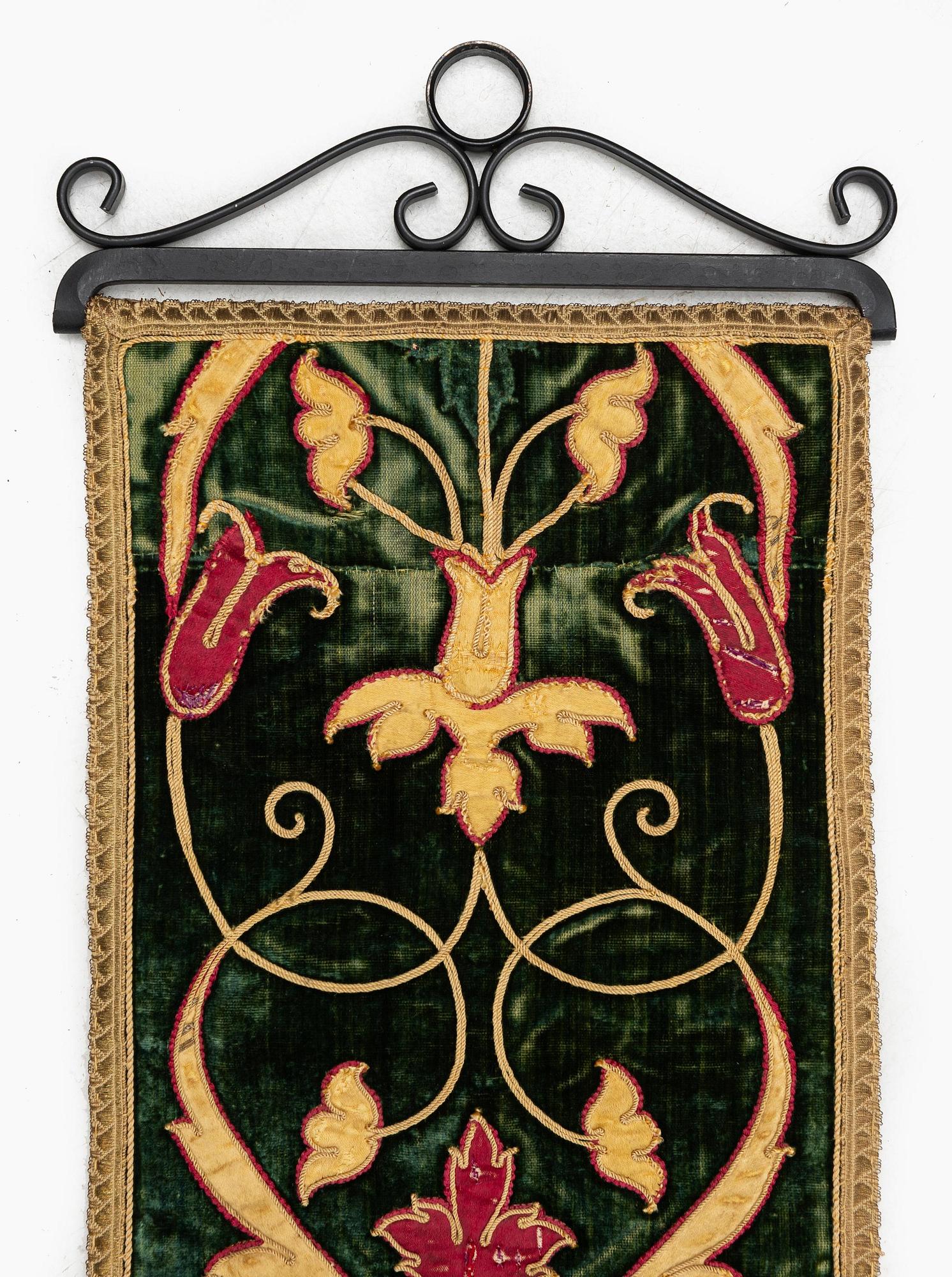 A 17th century Spanish embroidered velvet panel, c. 77 x 18.5 cm.