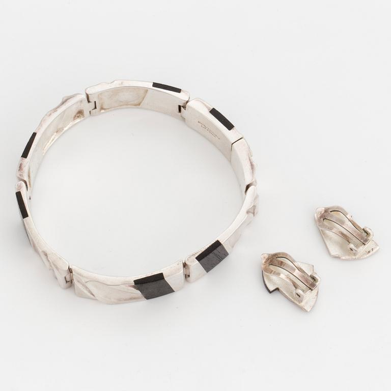 A silver 'Bantu' bracelet and pair of earrings inlaid with ebeny by Zoltan Popovits for Lapponia.