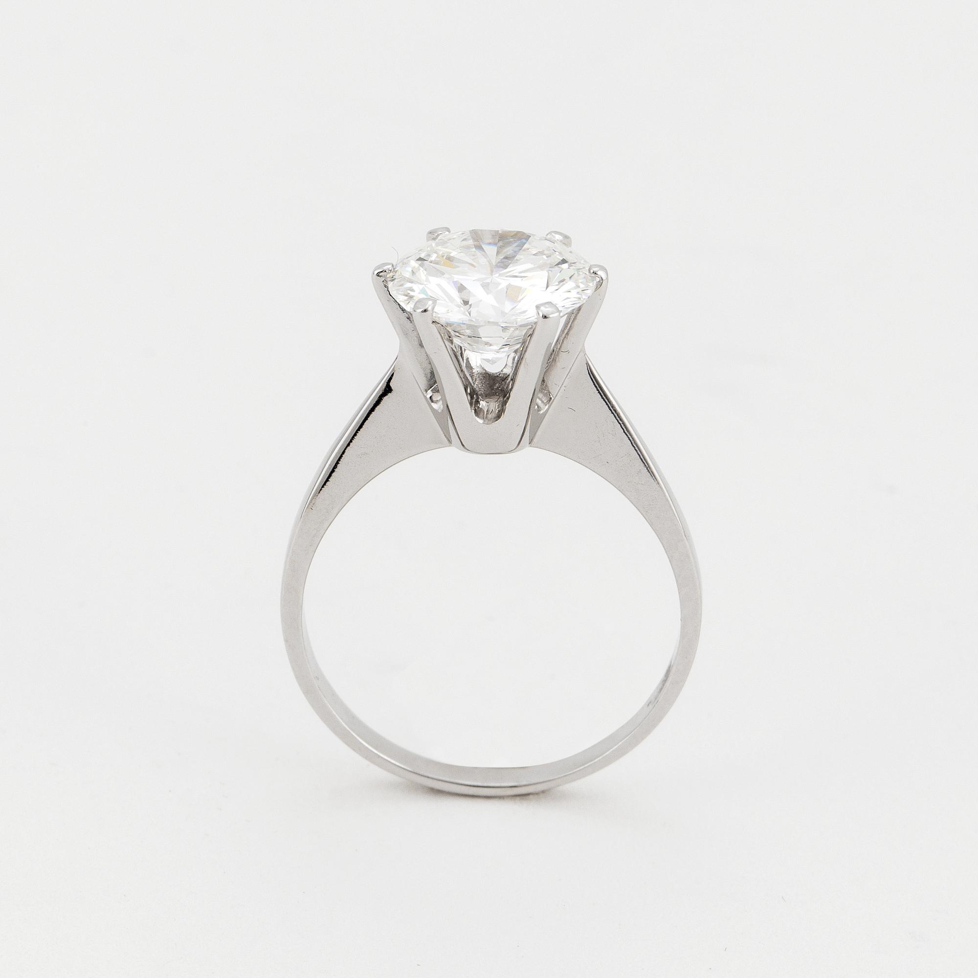 A SOLITAIRE RING set with a round brilliant-cut diamond.