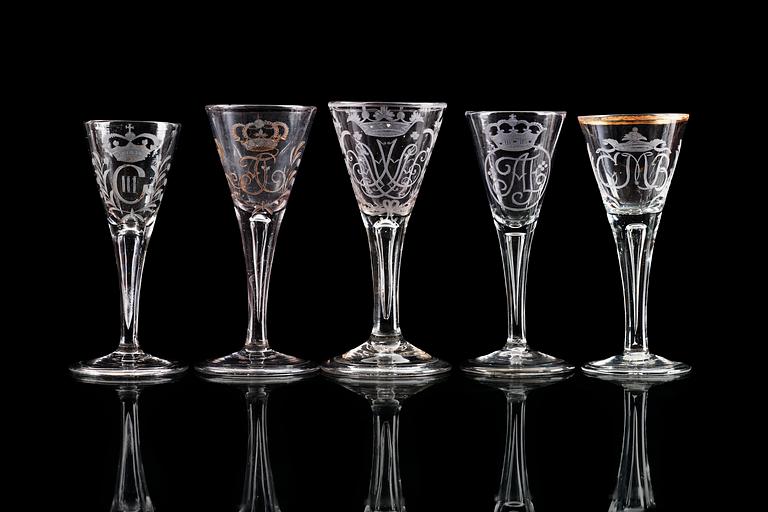 A group of five odd engraved wine glasses, 18th Century.