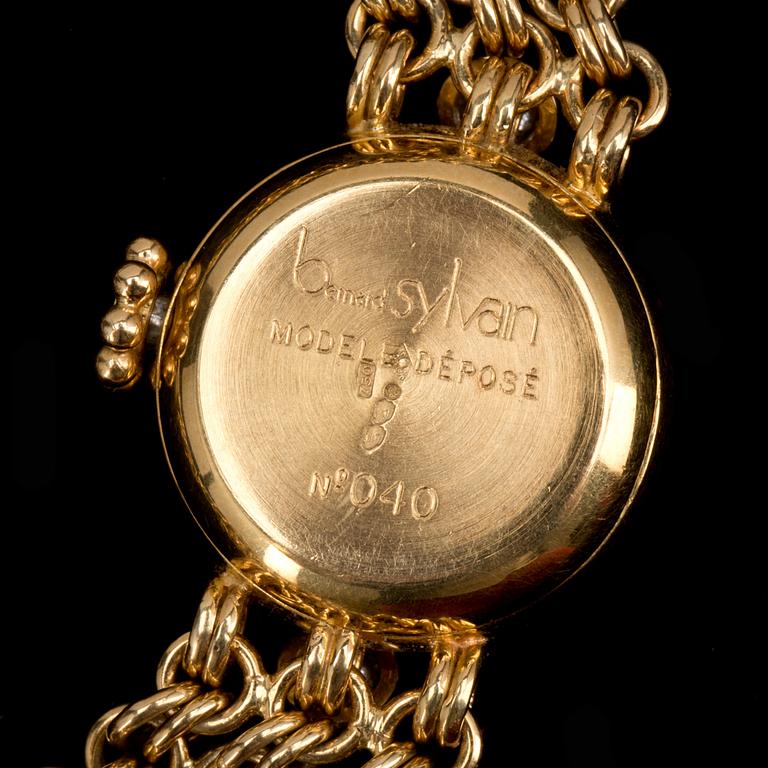 ARMBANDSUR, 18K guld med briljantslipade diamanter ca 0,60ct, Bernard Sylvain, Paris. Vikt ca 56g.