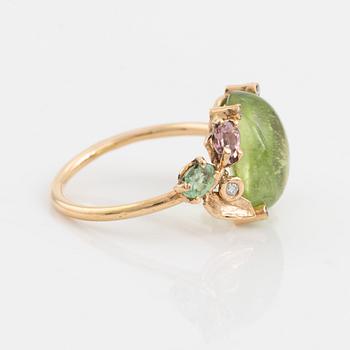 Ring with cabochon-cut peridot, tourmaline, and small diamonds.