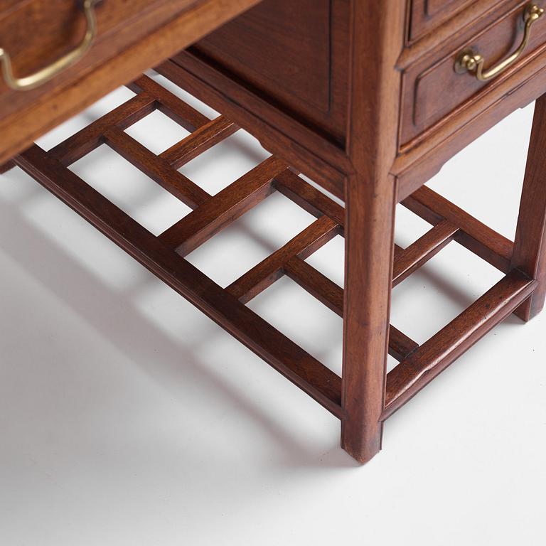 A six-drawer 'jichimu' pedestal partners desk, late Qing dynasty/early 20th century.