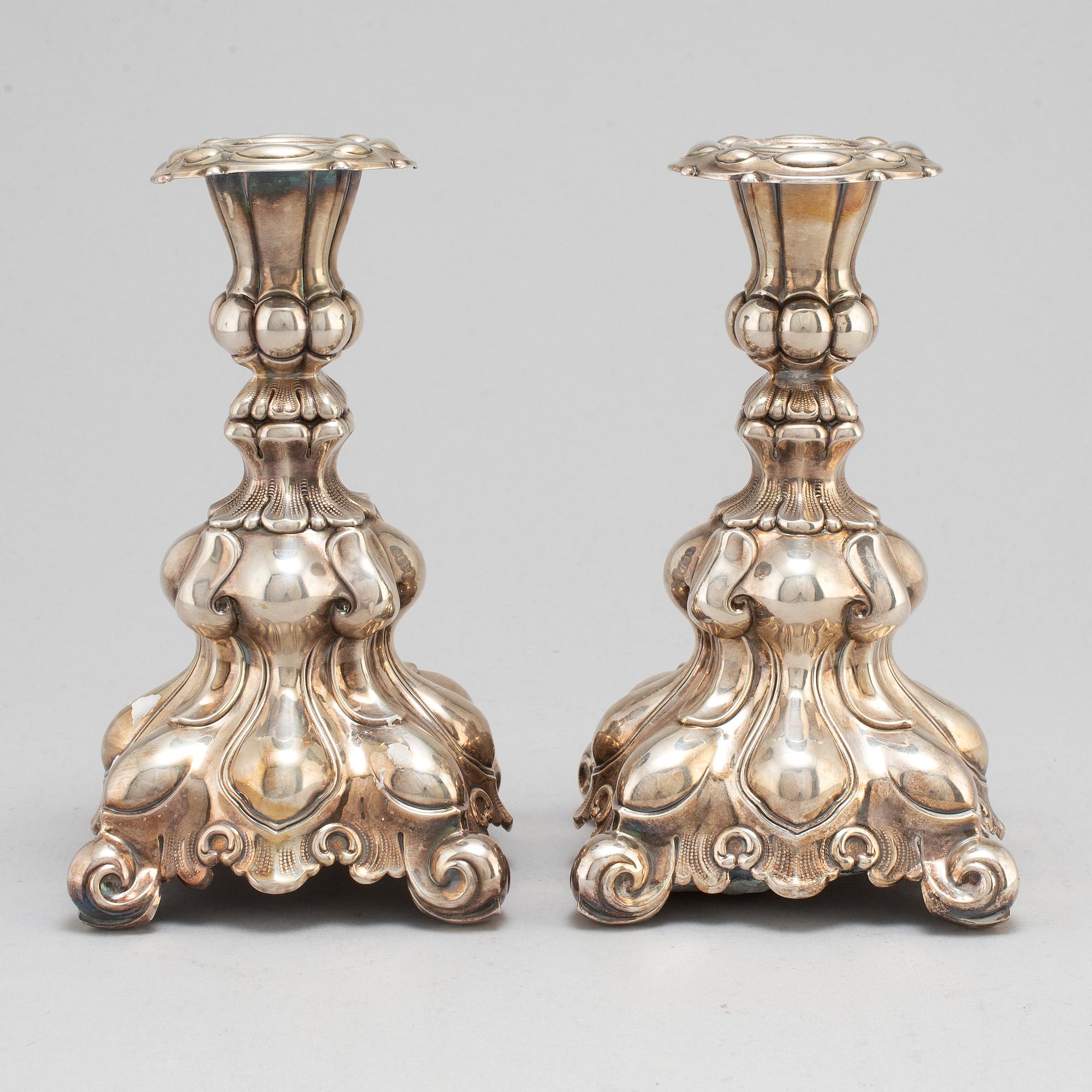 A pair of silver candle sticks.-.