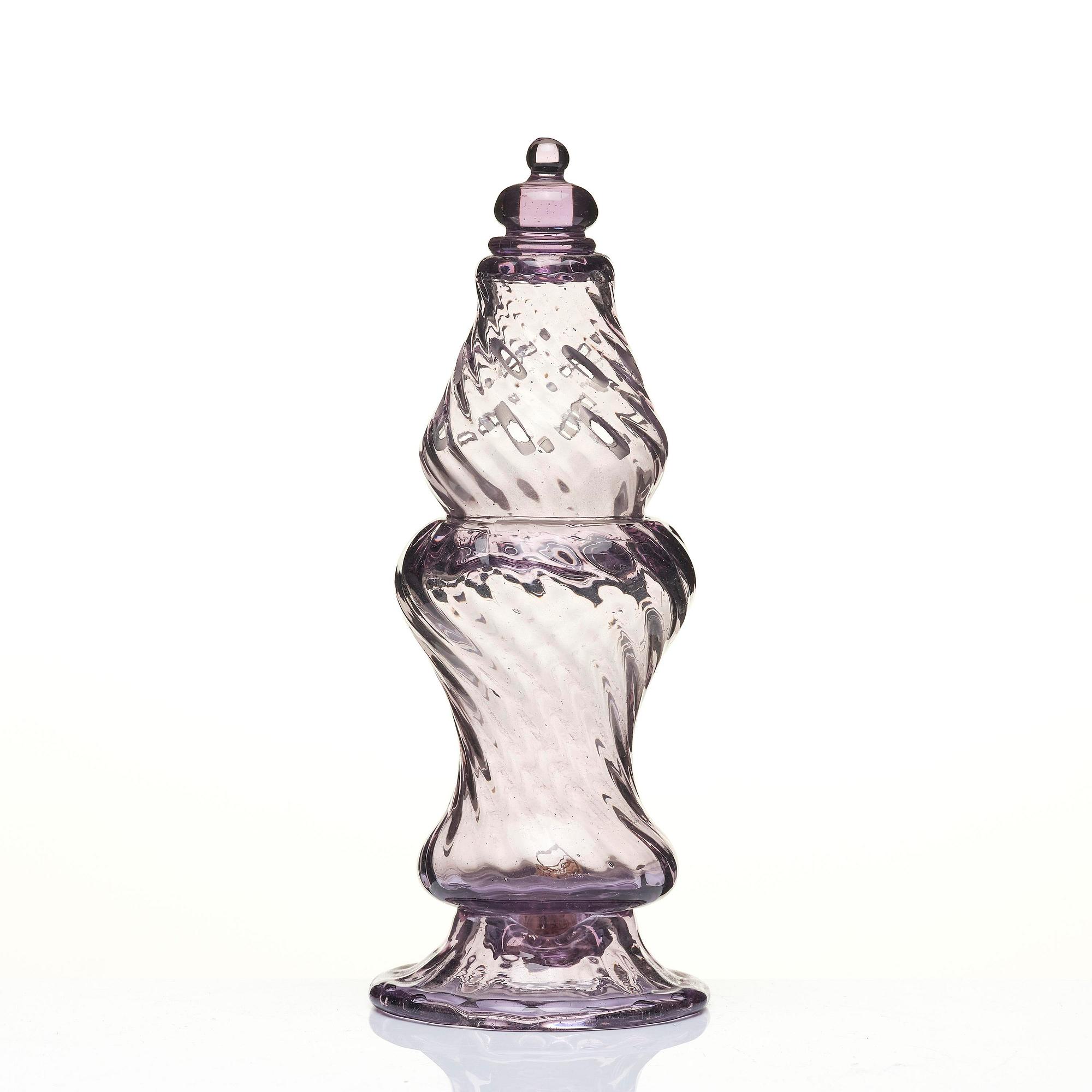 An amethyst coloured suger shaker and a cut glass goblet, 18th century.