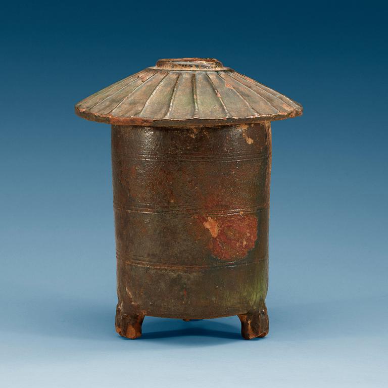 A green glazed grain storage, Han dynasty (206 BC – AD 220).