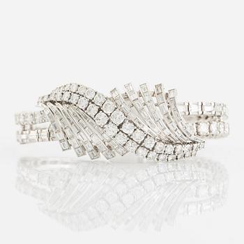 555. A platinum bracelet set with round brilliant- and baguette-cut diamonds.