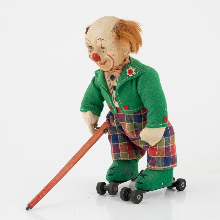A set of five toys, including 'Rolly' clown from Schuco, 20th century.